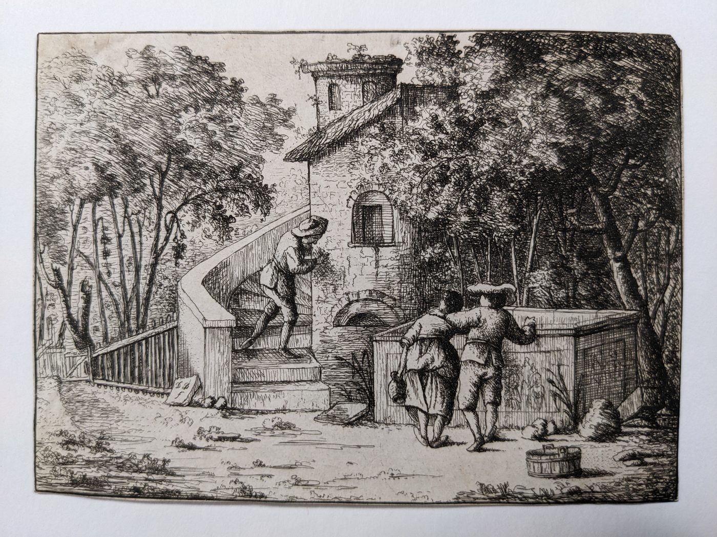 Man writing graffiti on a tower wall from a staircase, watched by two peasants near a large stone tomb